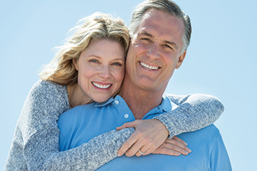 A couple smiling at the camera. Links to Under Age 60